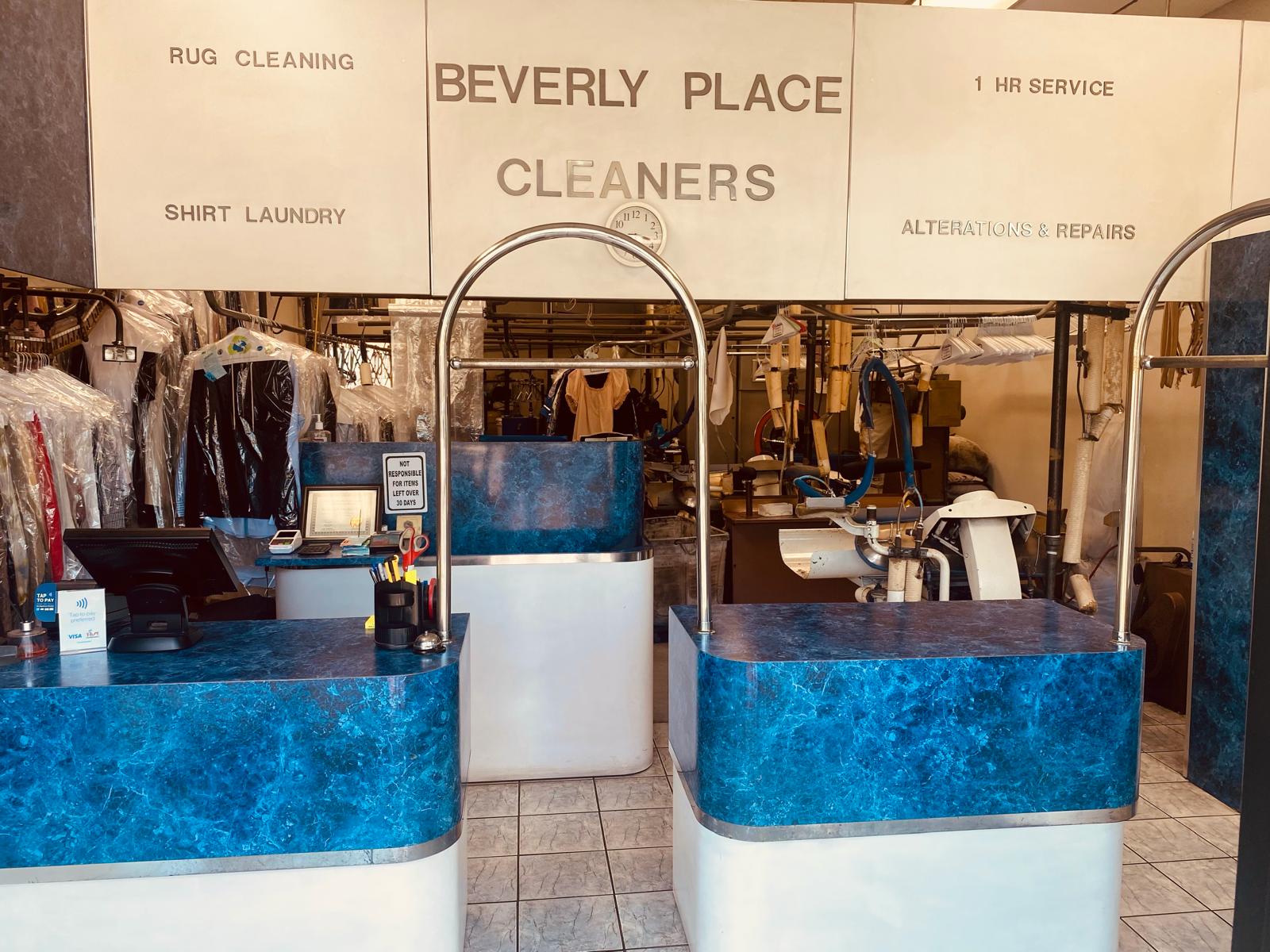 Inside the Beverly Place Cleaners shop, with counters and freshly cleaned garments